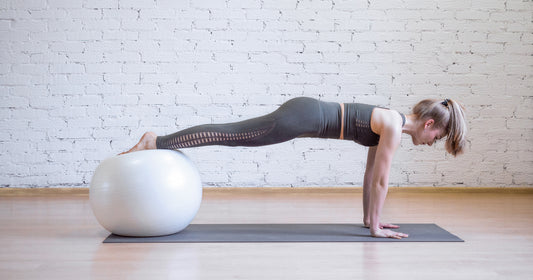 a woman doing plank position using math and fitness ball
