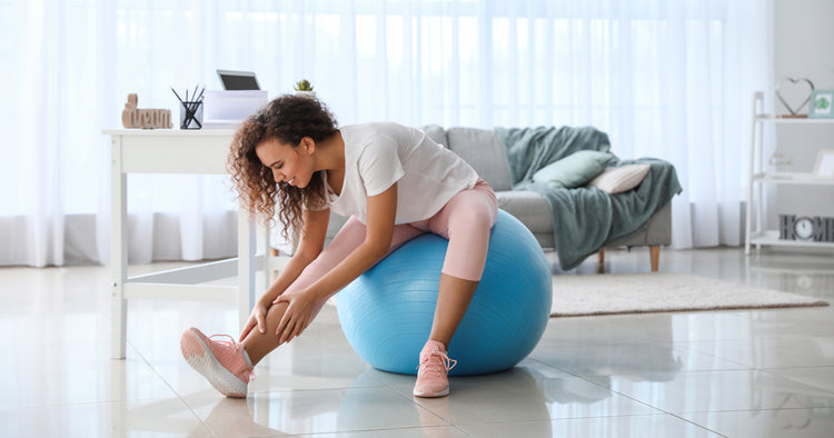 A lady is exercising with an gym ball