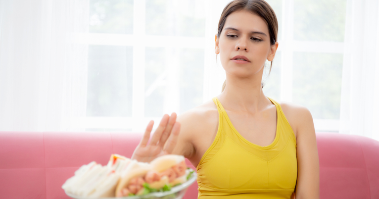 reasons undereating actually delays progress woman refuses food