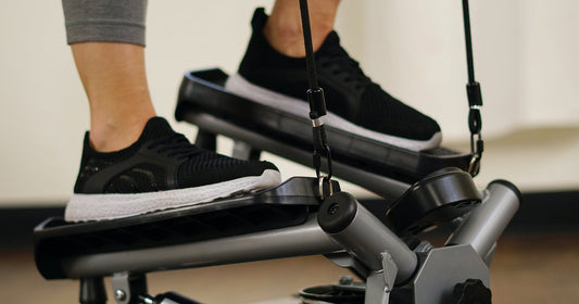 a woman is stepping on mini stepper