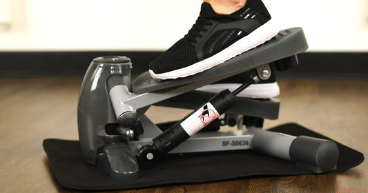 a man is stepping on mini stepper