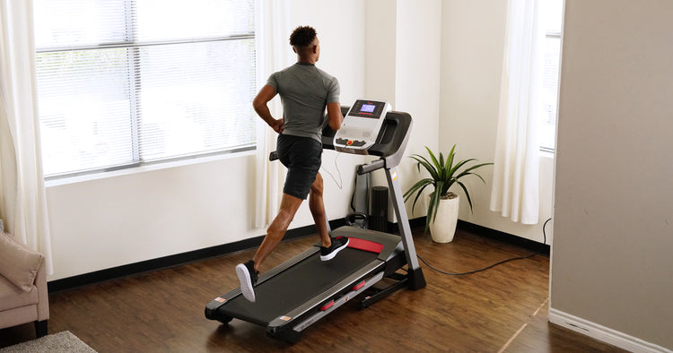 a man is running on Sunny treadmill
