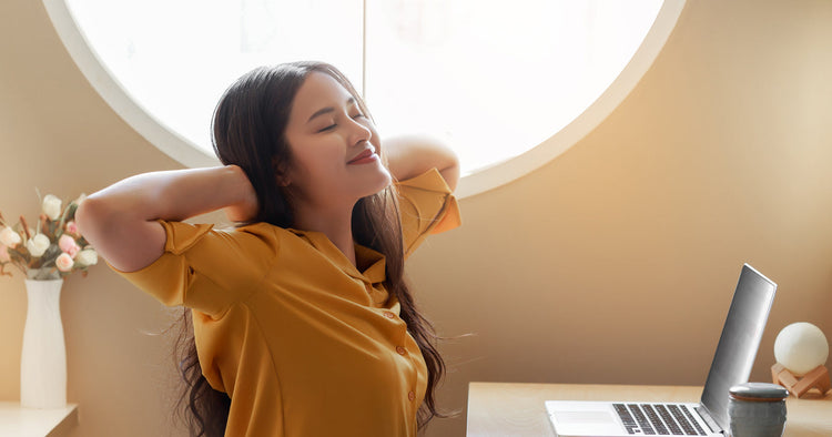 A student stretching after studying