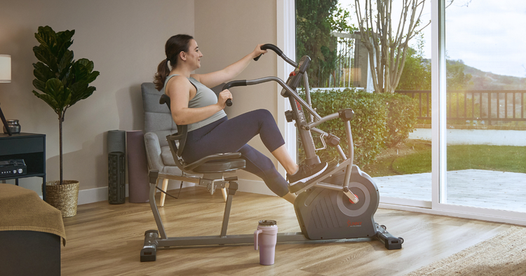woman rides recumbent bike in her home