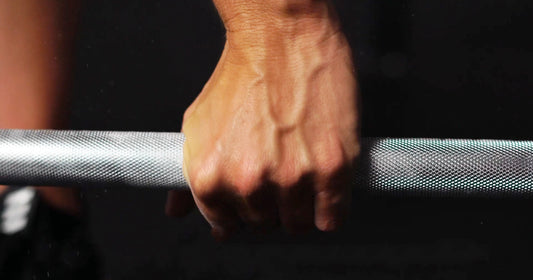 a hand is holding Olympic Bar