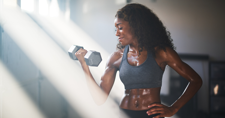 woman does biceps curl during workout