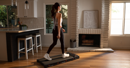 Woman walking on tread pad indoors.