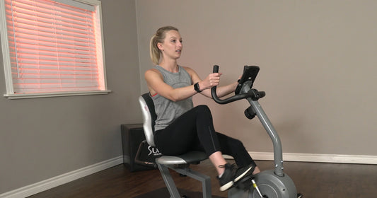 Sunny fitness trainer Sydney is riding recumbent bike