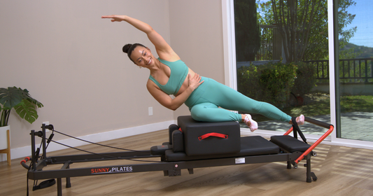 Woman using reformer pilates.