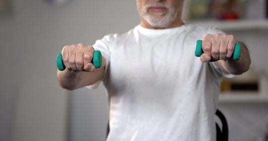 man holding green dumbbells in each hand