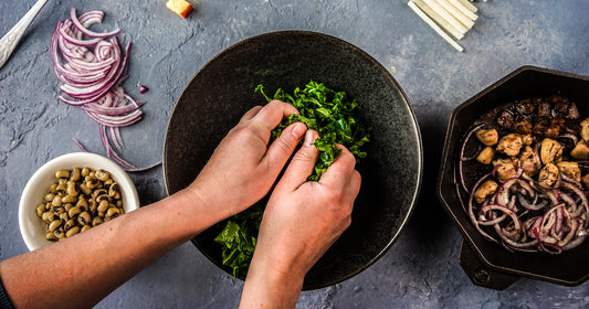 woman hands working on kale salad