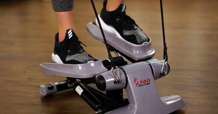 a woman is working out on a stepper