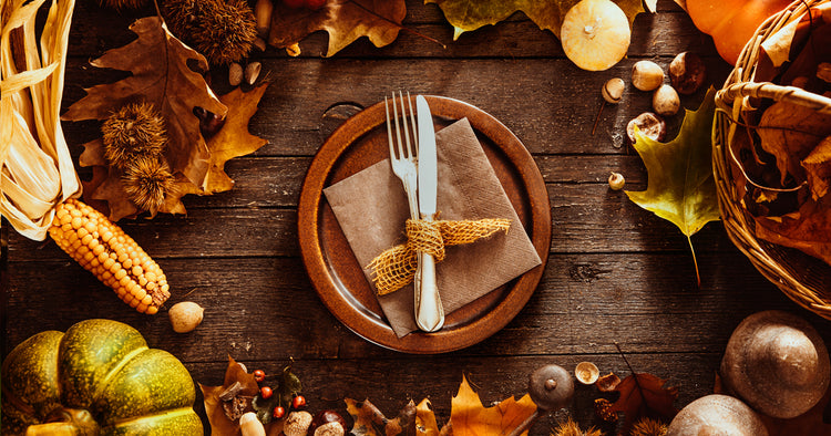fork and knife on a plate, surrounded by fall ingredients