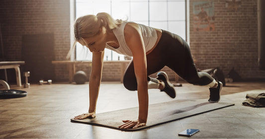a woman is doing running plank