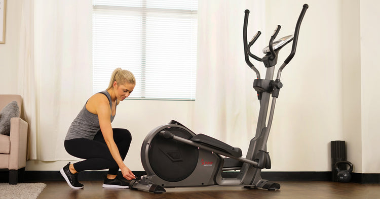 a trainer is ready to use an ellipitical machine
