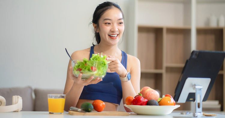 Woman holding up a salad