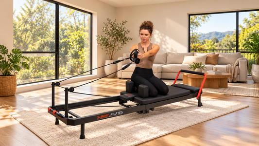 Woman in living room using reformer pilates. 
