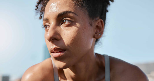 Close-up shot of an athletic woman sweating, look to the left, and  taking a break from fitness, exercise and workout.