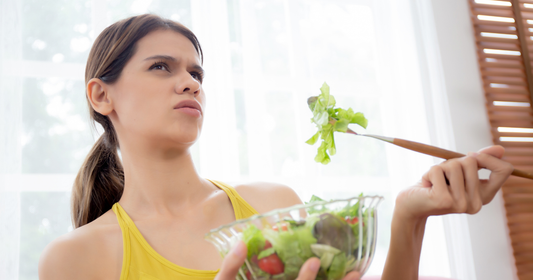 woman is confused eating a salad from common fitness myths