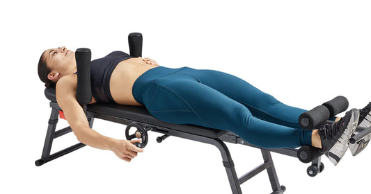 woman uses spinal decompression stretch table for spine relief
