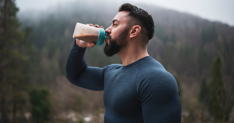 what to eat on training days vs rest days man drinks protein drink after workout outdoors