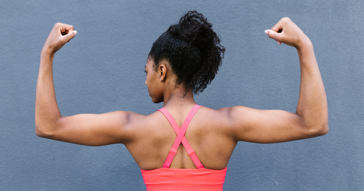 what to eat to build muscle woman flexes her muscles