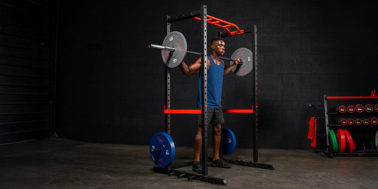 Man weight lifting using Sunny Health & Fitness Squat Power Cage