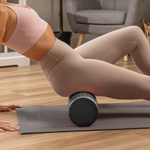 Glute Roll | Sit on the roller and roll one glute at a time to relieve hip tightness.