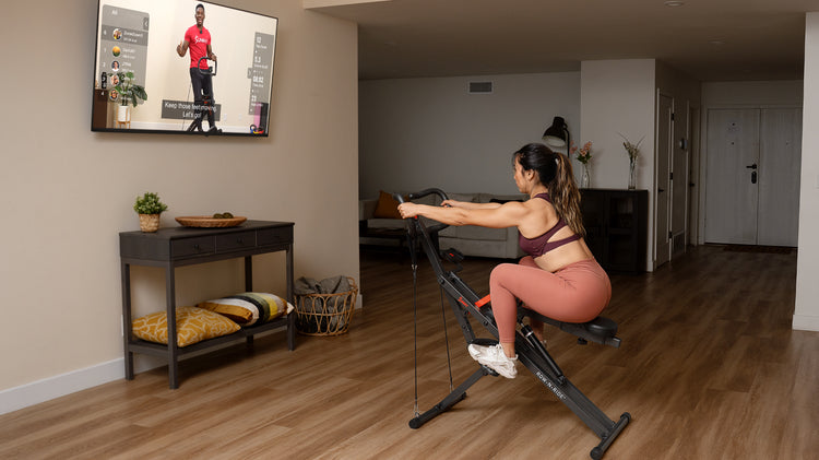 woman exercising on row-n-ride squat machine