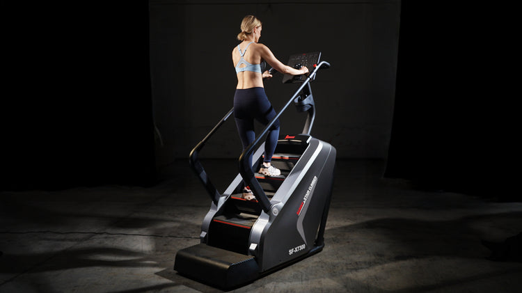 Woman exercising on stair climbing machine