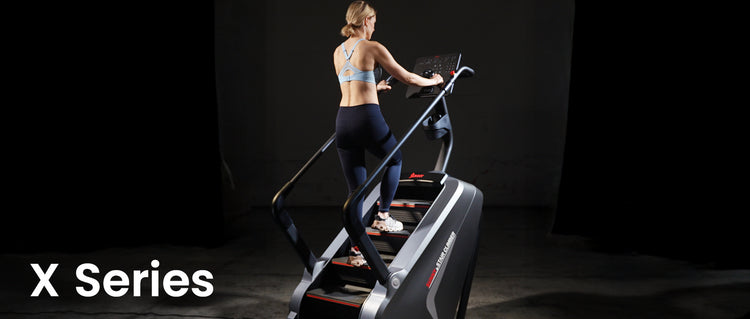 Woman using a treadmill with 'X Series' branding in a dark setting