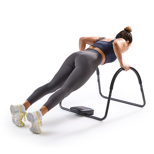 Push-Ups | Hands are placed on the rocker handles while lowering and lifting the body to work the chest, shoulders, and triceps.