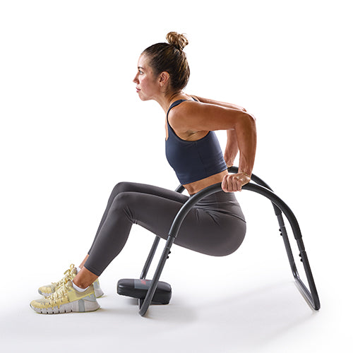 Tricep Dips | The body is lowered in front of the rocker using the arms to target the triceps.