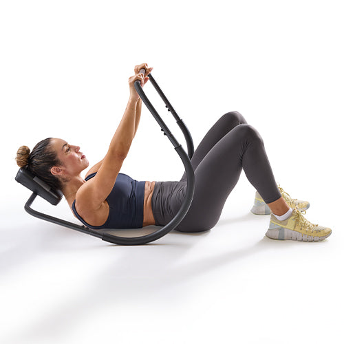Standard Crunches | The upper body lifts slightly off the backrest to engage the abdominal muscles.