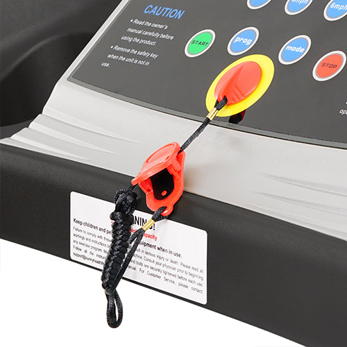 Red treadmill emergency stop safety clip attached to a console